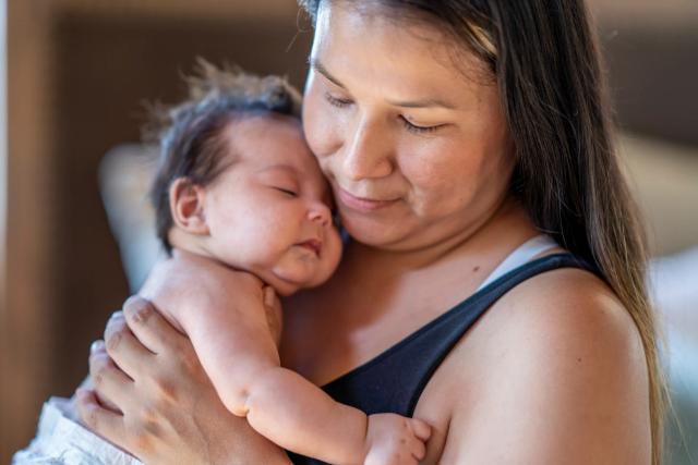 Mother holding a sleeping baby