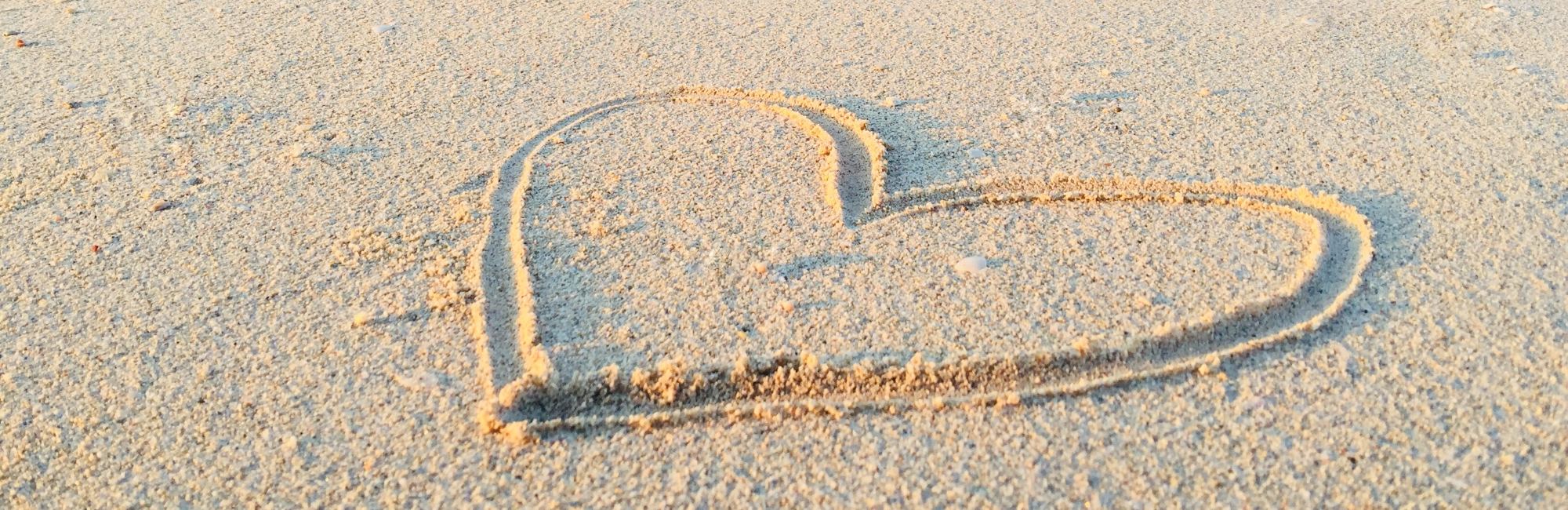 love heart drawn in sand